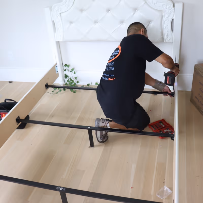 Boston Best Rate Movers crew member assembling furniture at destination