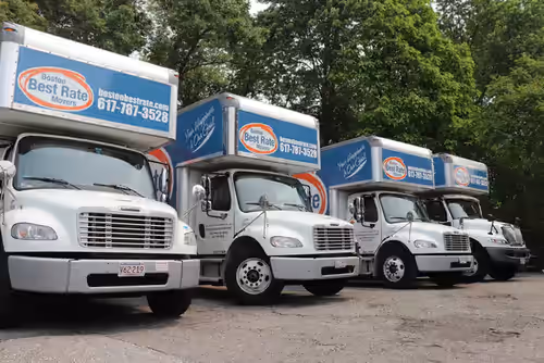 Boston Best Rate Movers crew group photo in front of branded moving truck fleet