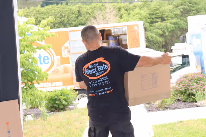 Boston Best Rate Movers professional carrying boxes during a residential move