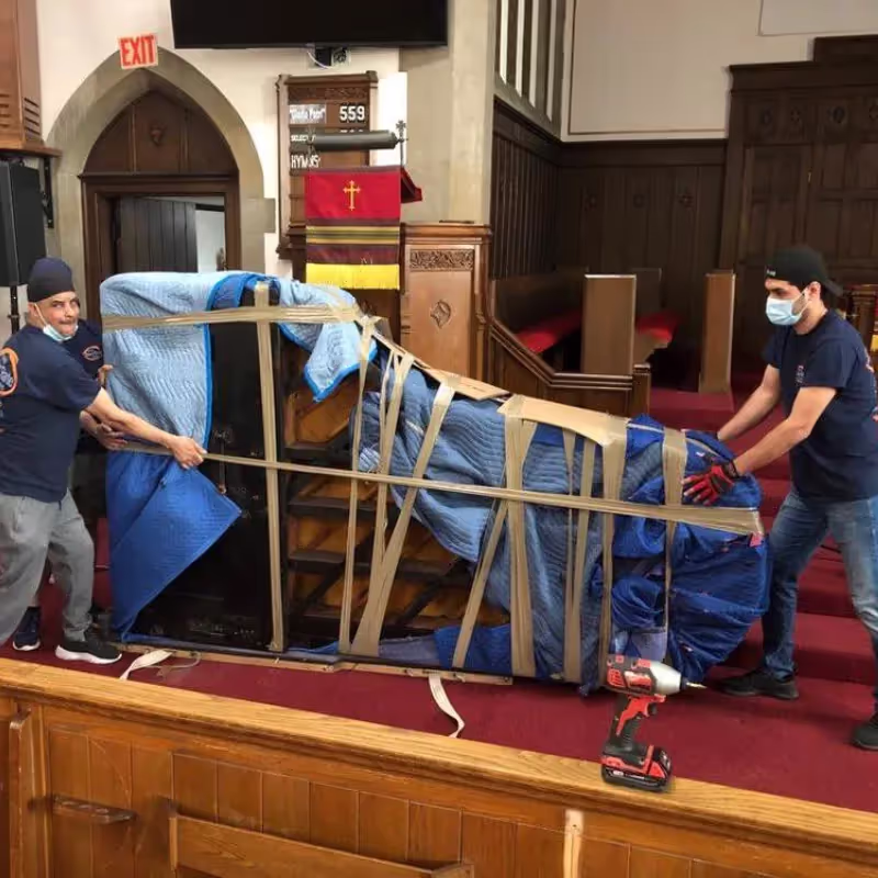 Piano being wrapped and protected for transport