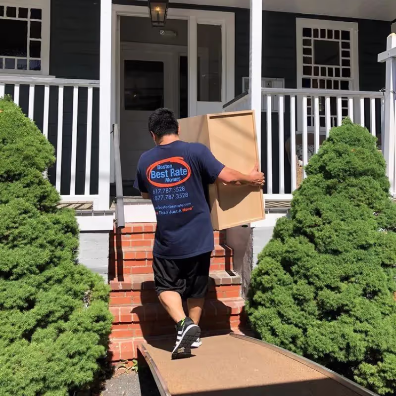 Boston Best Rate Movers team carrying boxes down stairs during a residential move