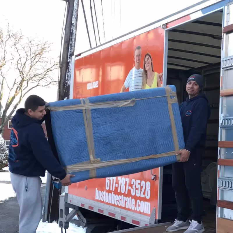 Boston Best Rate Movers truck and crew on a tree-lined residential street during a local Boston move